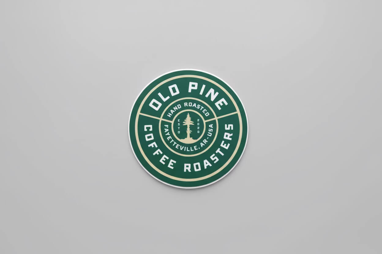 Green Old Pine branded badge sticker, circular design with signature logo 