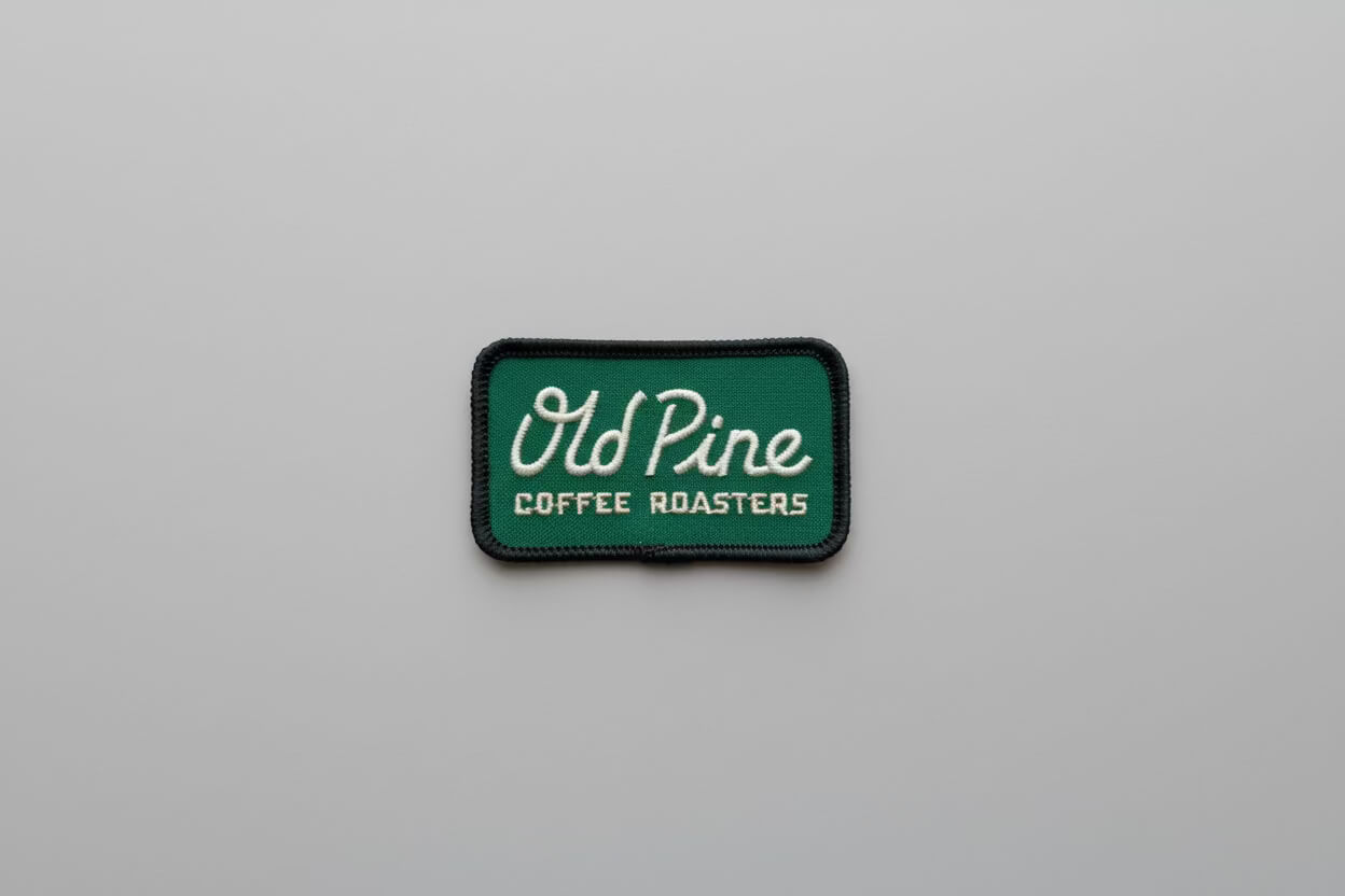 Green patch with 'Old Pine Coffee Roasters' text on a gray background