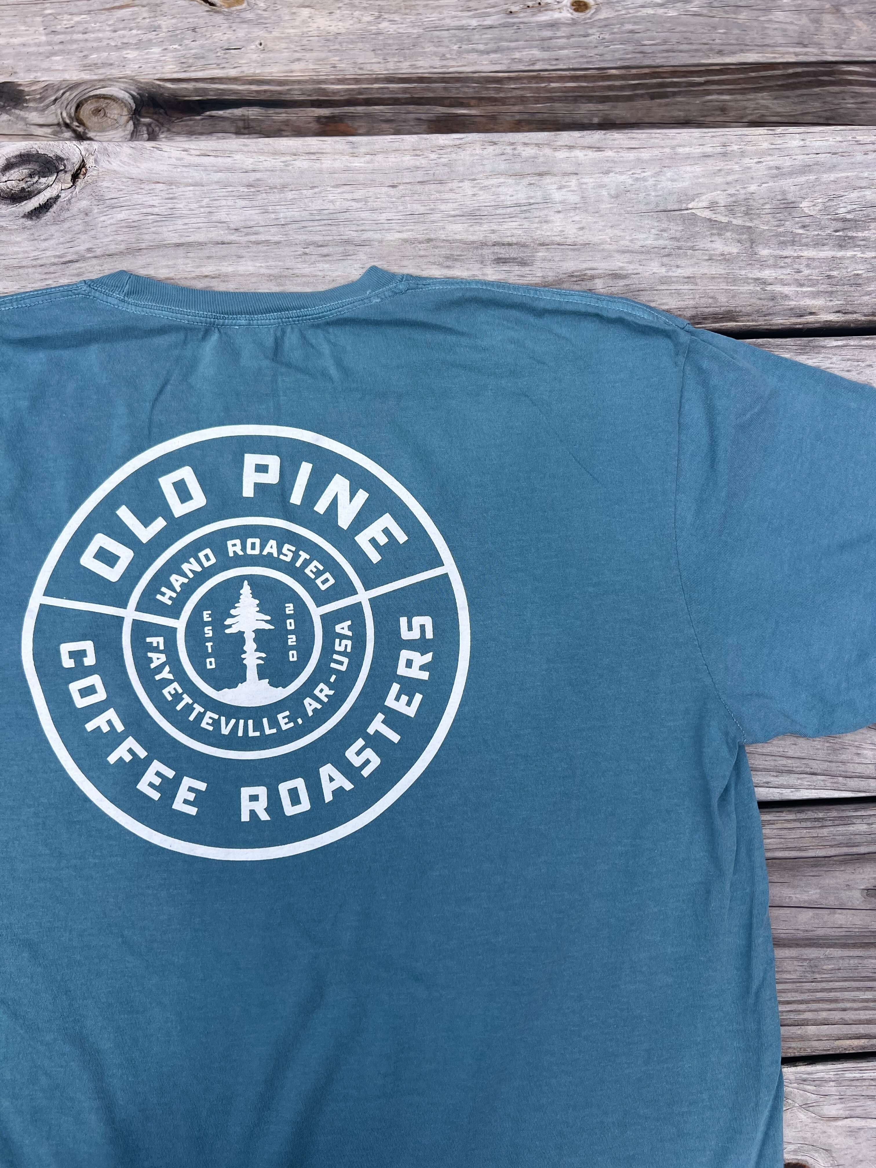 Blue t-shirt with Old Pine Coffee Roasters badge logo on back of shirt