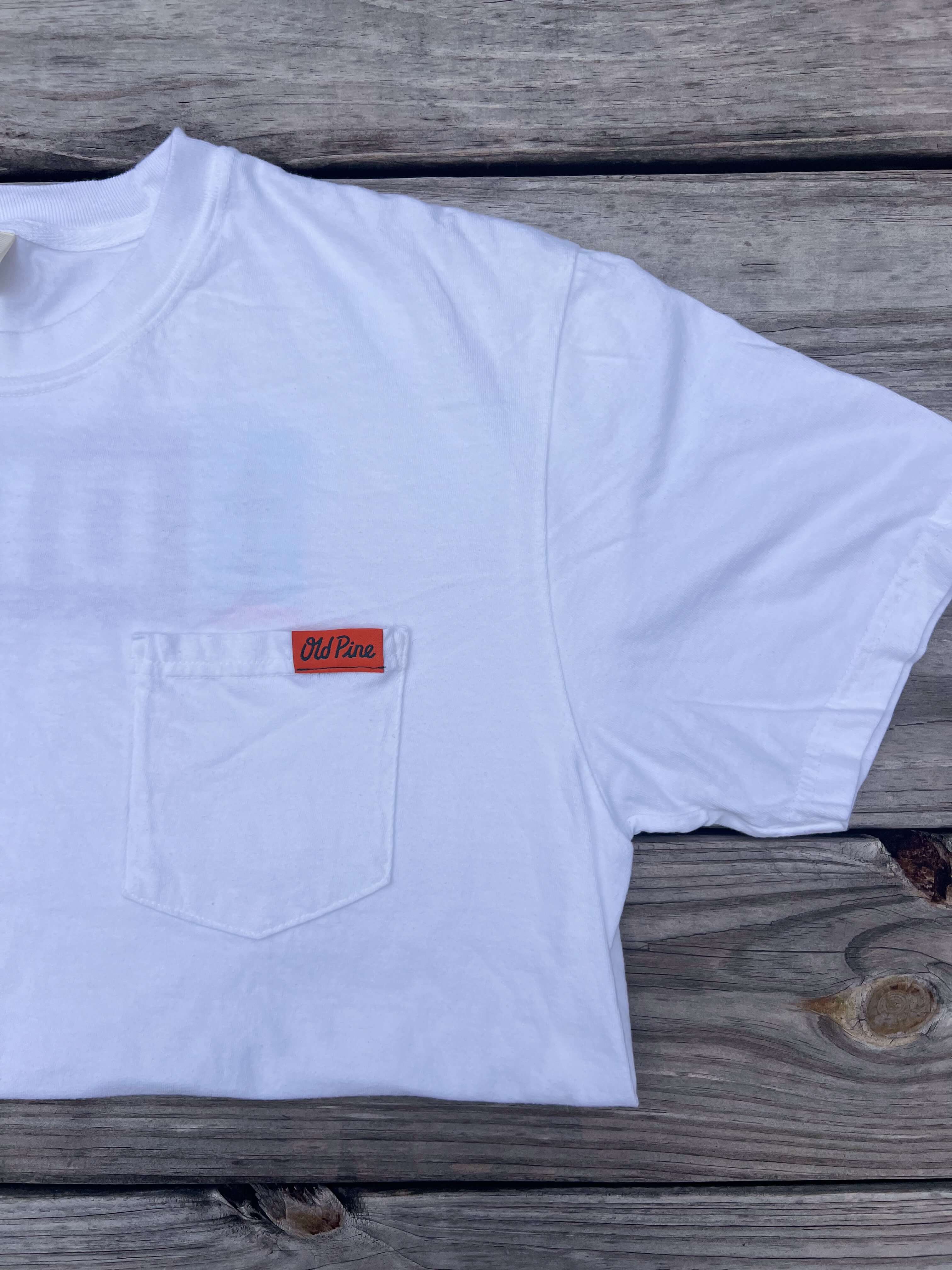White t-shirt with a front pocket that has orange "old pine" label 