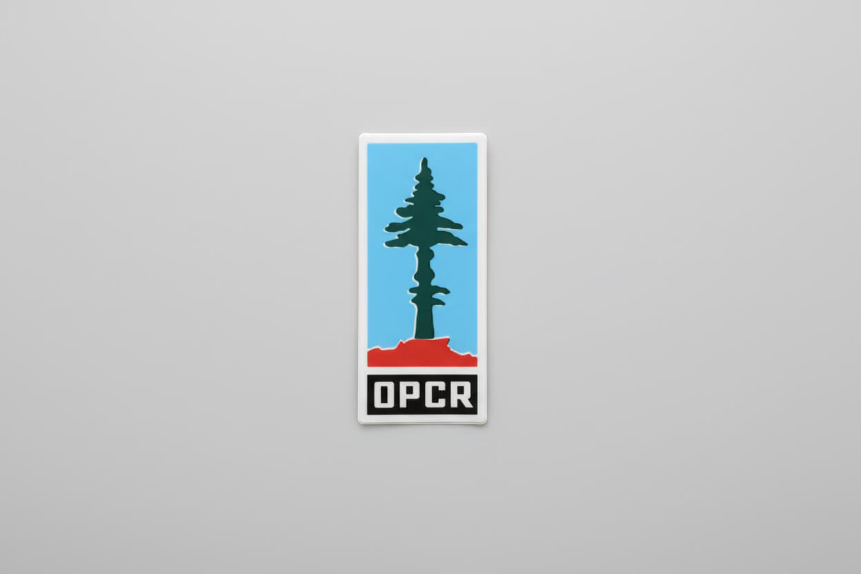 Sticker with a tree design and 'OPCR' text on a gray background
