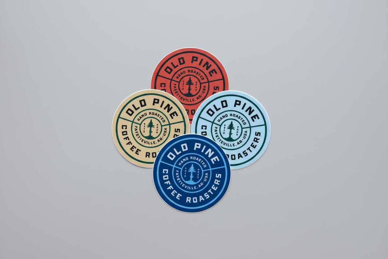 Four Old Pine branded badge stickers, circular design with signature logo and variety of colors
